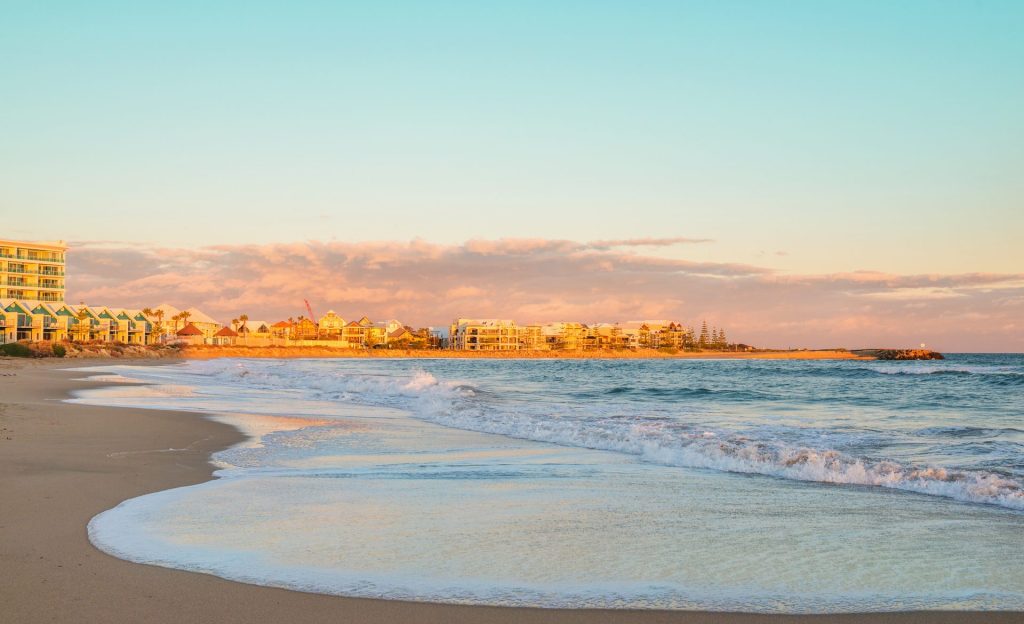 Golden sunset over coastal beach and apartments