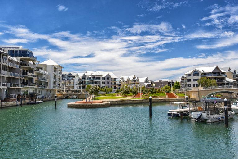 Waterfront apartments and boats along calm marina