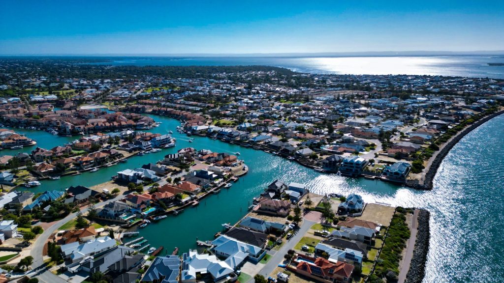 Aerial view of coastal canal suburb by ocean