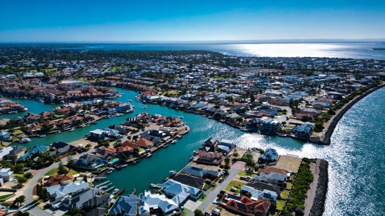 Aerial view of coastal canal suburb by ocean