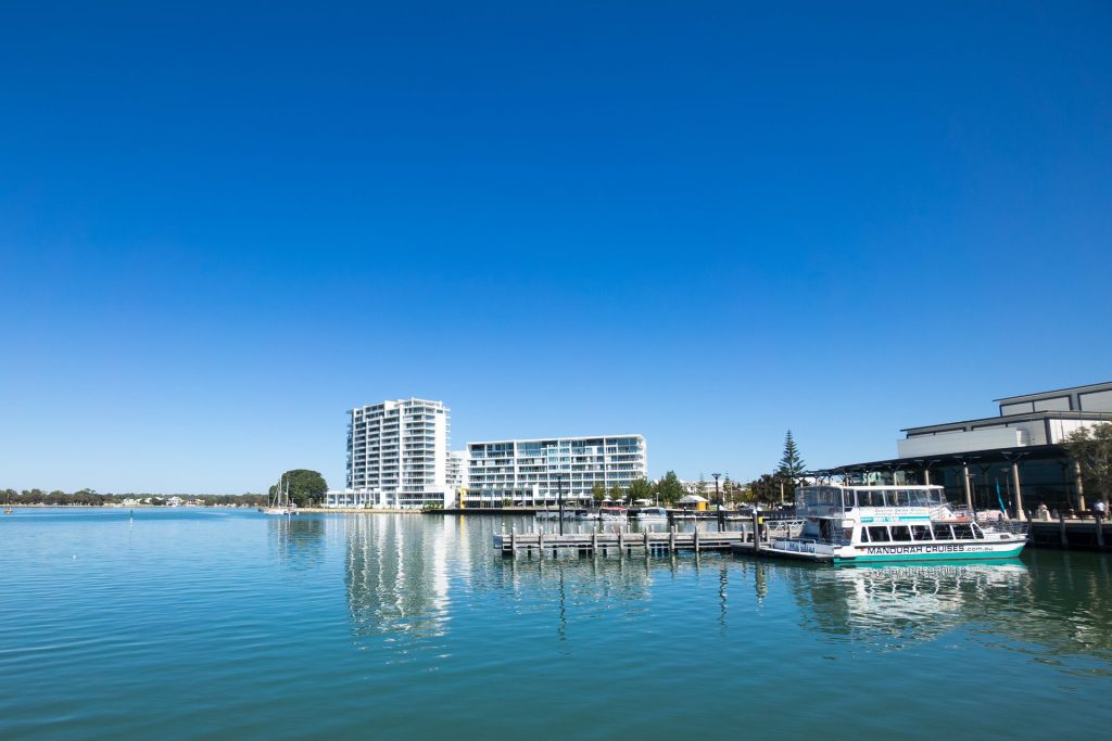 Mandurah marina with apartments and cruise boat