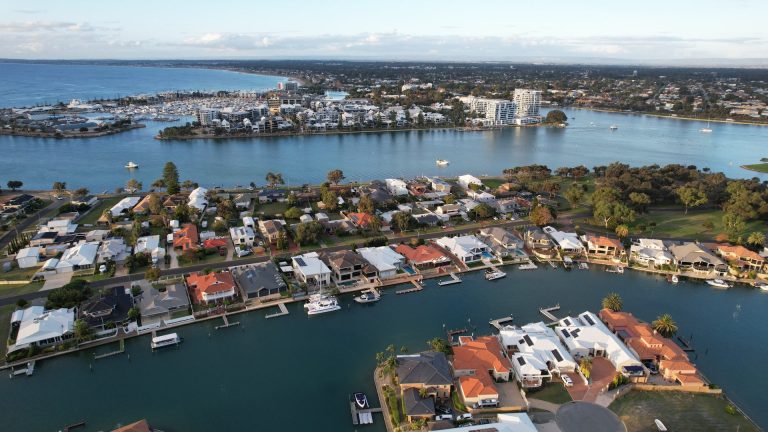 Aerial view of waterfront homes and marina